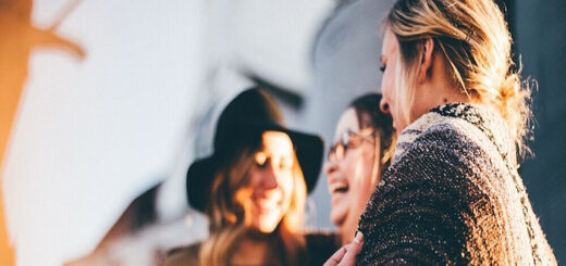 a group of women laughing together all with different body types