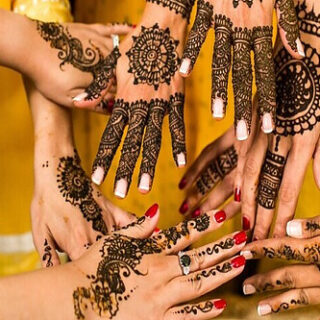 a group of women holding out their tattood hands