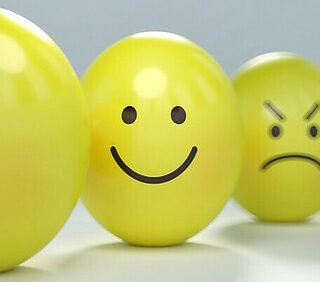 emotions drawn on yellow balls with the happy face in focus
