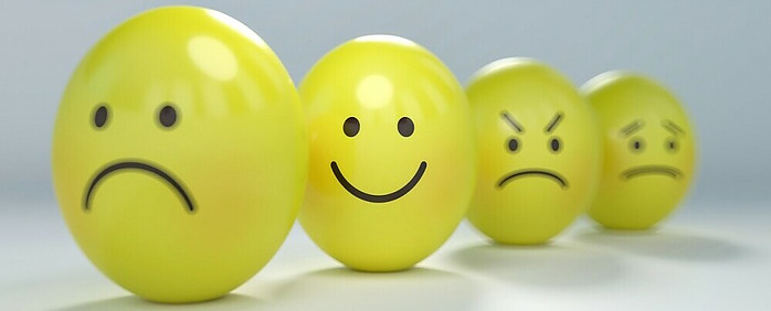 emotions drawn on yellow balls with the happy face in focus